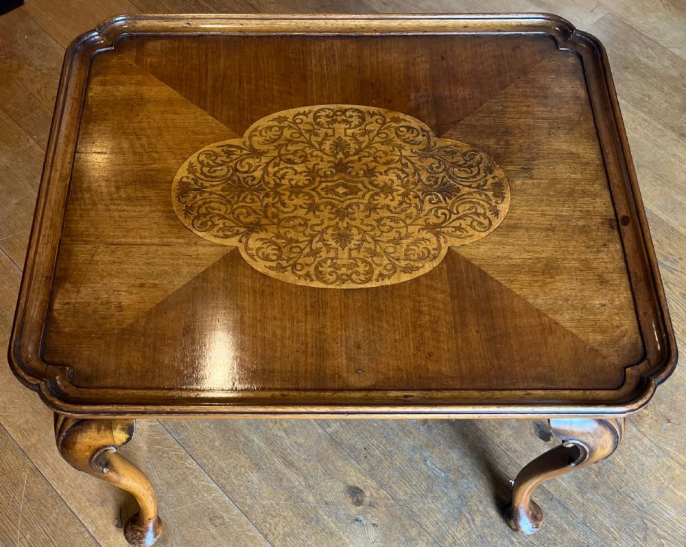 A square walnut Queen Anne style coffee table featuring an inlaid central marquetry medallion, a raised tray rim, and curved cabriole legs ending in pad feet. View II