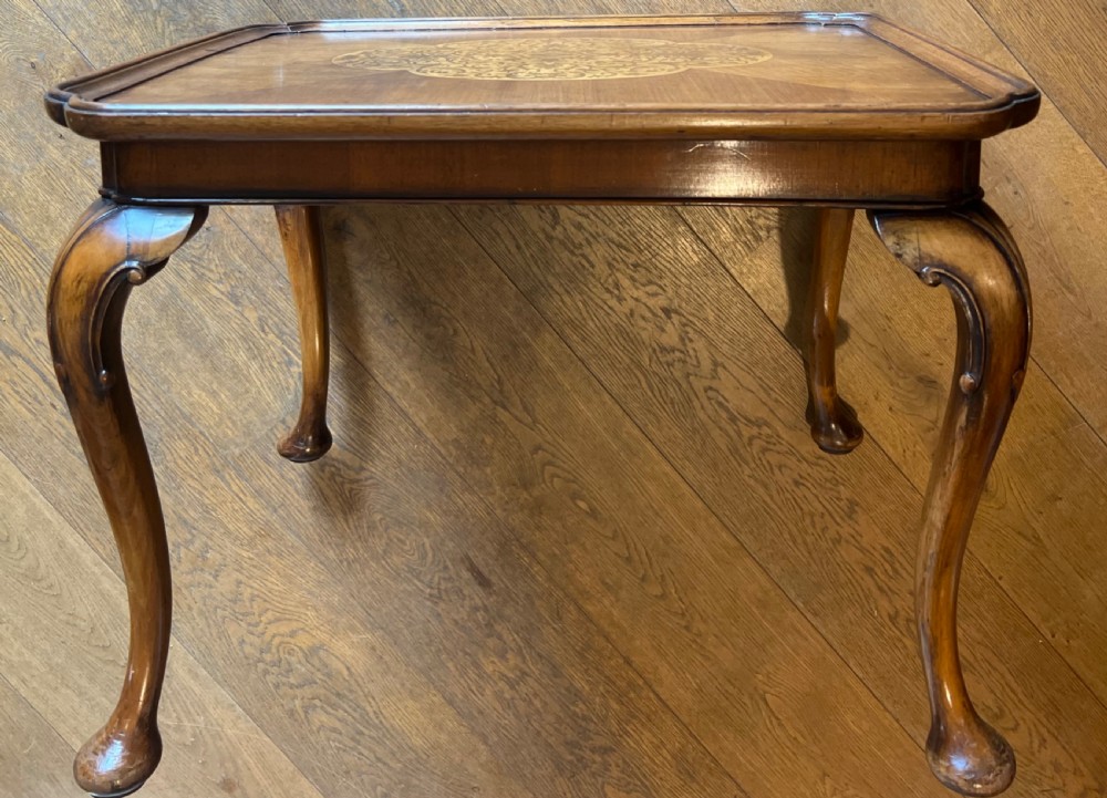 A square walnut Queen Anne style coffee table featuring an inlaid central marquetry medallion, a raised tray rim, and curved cabriole legs ending in pad feet. View V