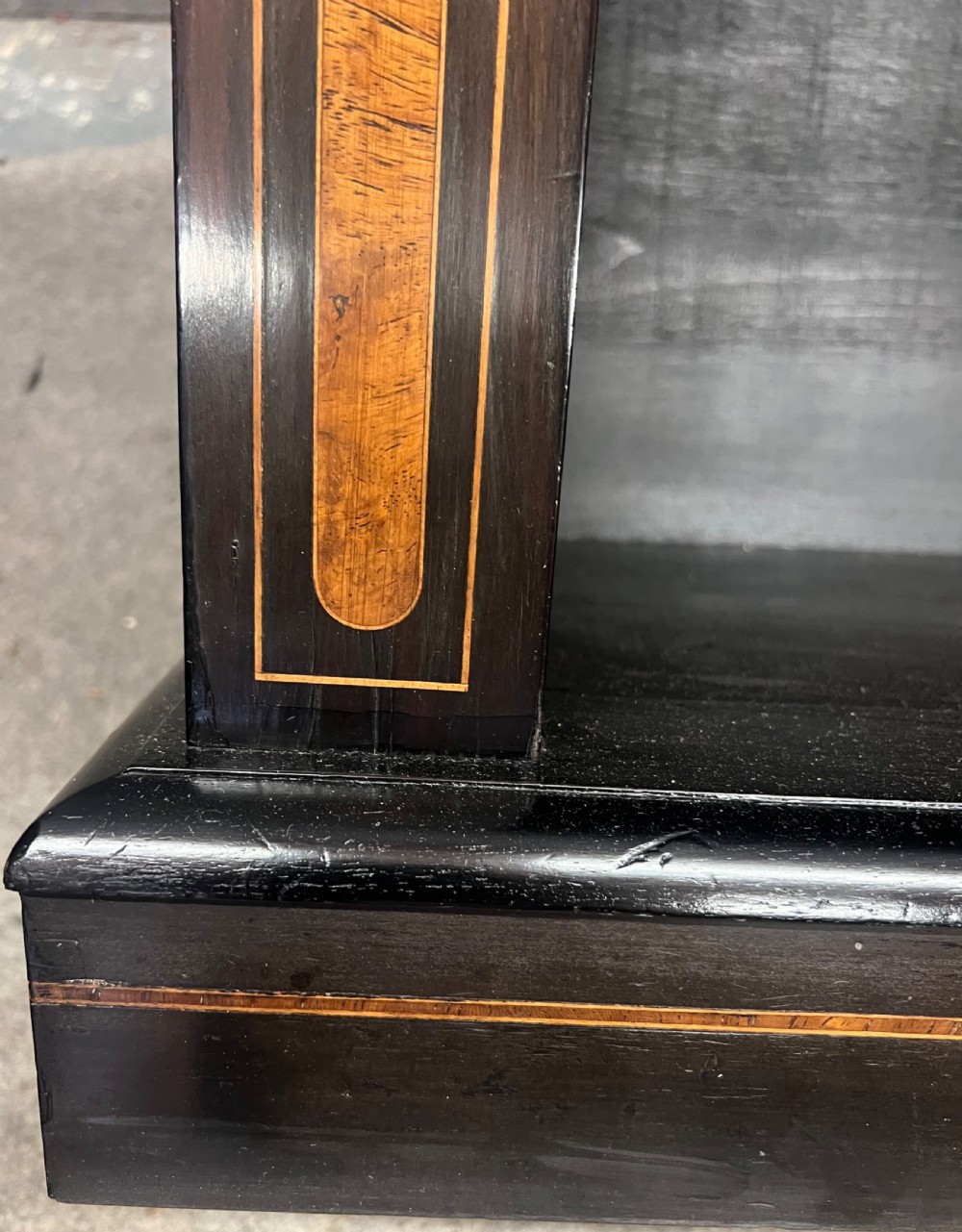 A small ebonised open bookcase with three shelves, featuring burr walnut inlay banding and thin brass moulding detailing. View III