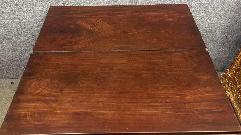 A Georgian dark mahogany fold-over table with straight square legs and a central brass swan-neck handle. View V
