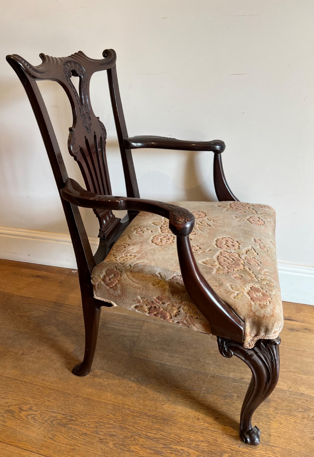 An 18th-century dark mahogany Chippendale armchair featuring a pierced carved back splat, curved arms, floral upholstered seat, and carved cabriole legs. View XI