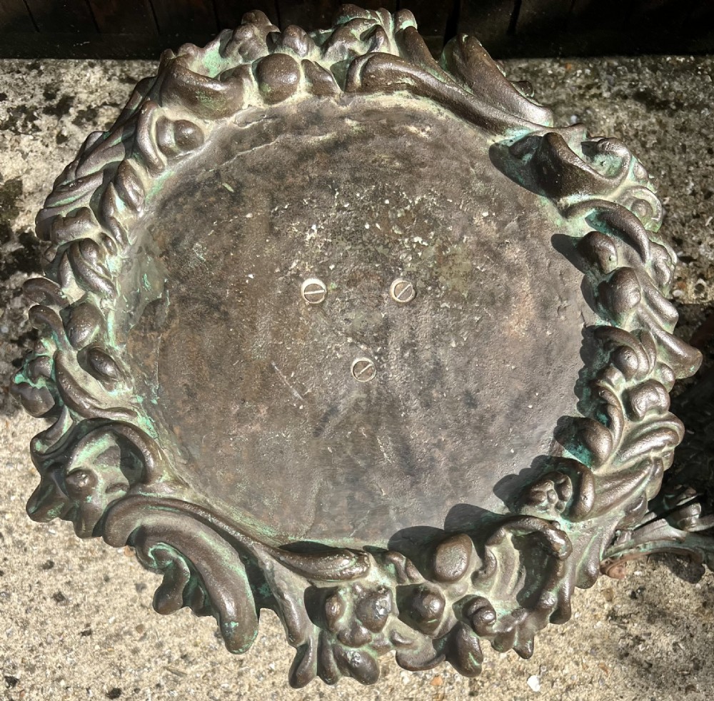 A pair of ornate cast iron pedestal tables with rococo scrollwork, tripod bases, and a verdigris green patinated finish. View III