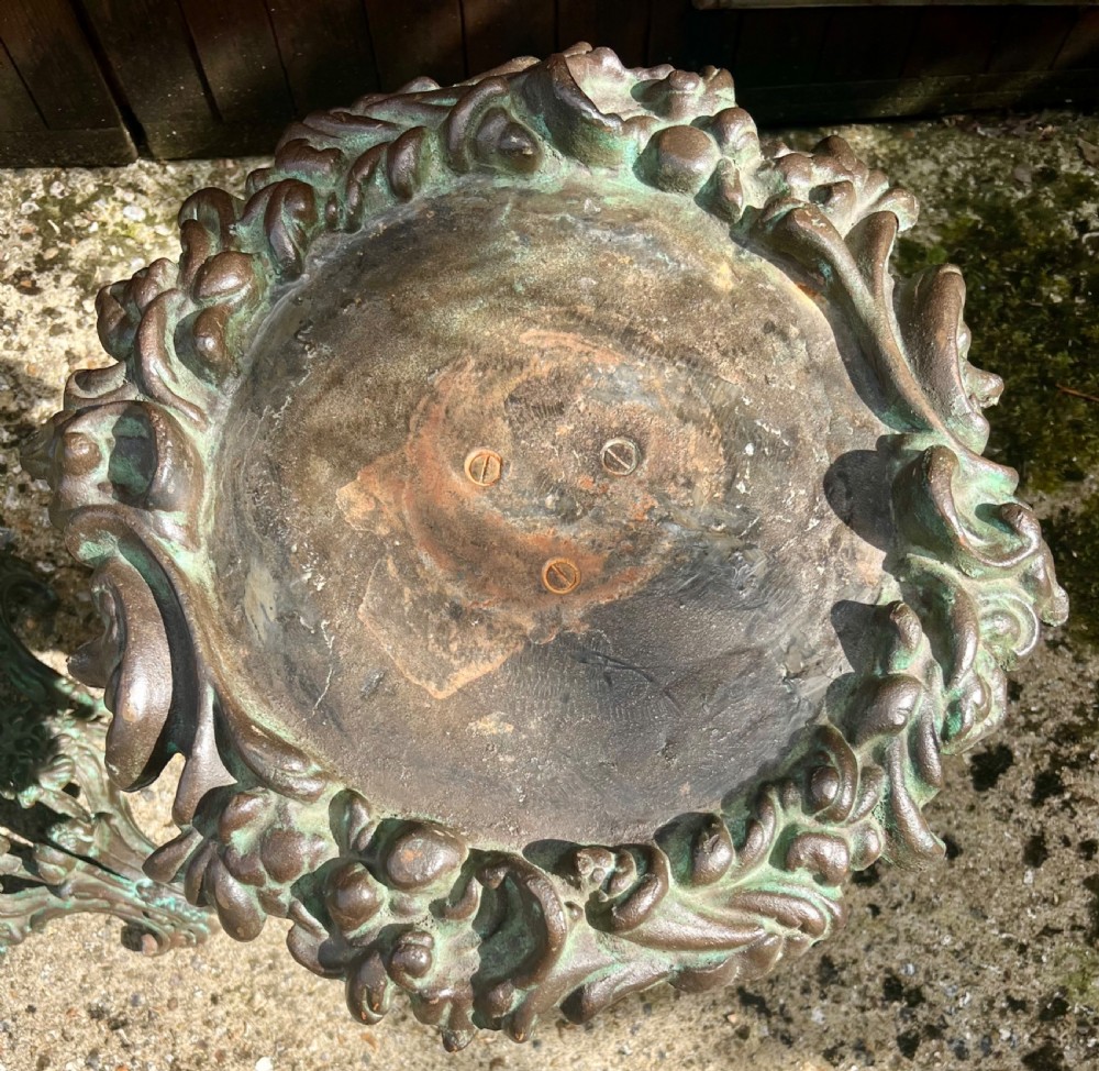 A pair of ornate cast iron pedestal tables with rococo scrollwork, tripod bases, and a verdigris green patinated finish. View IV
