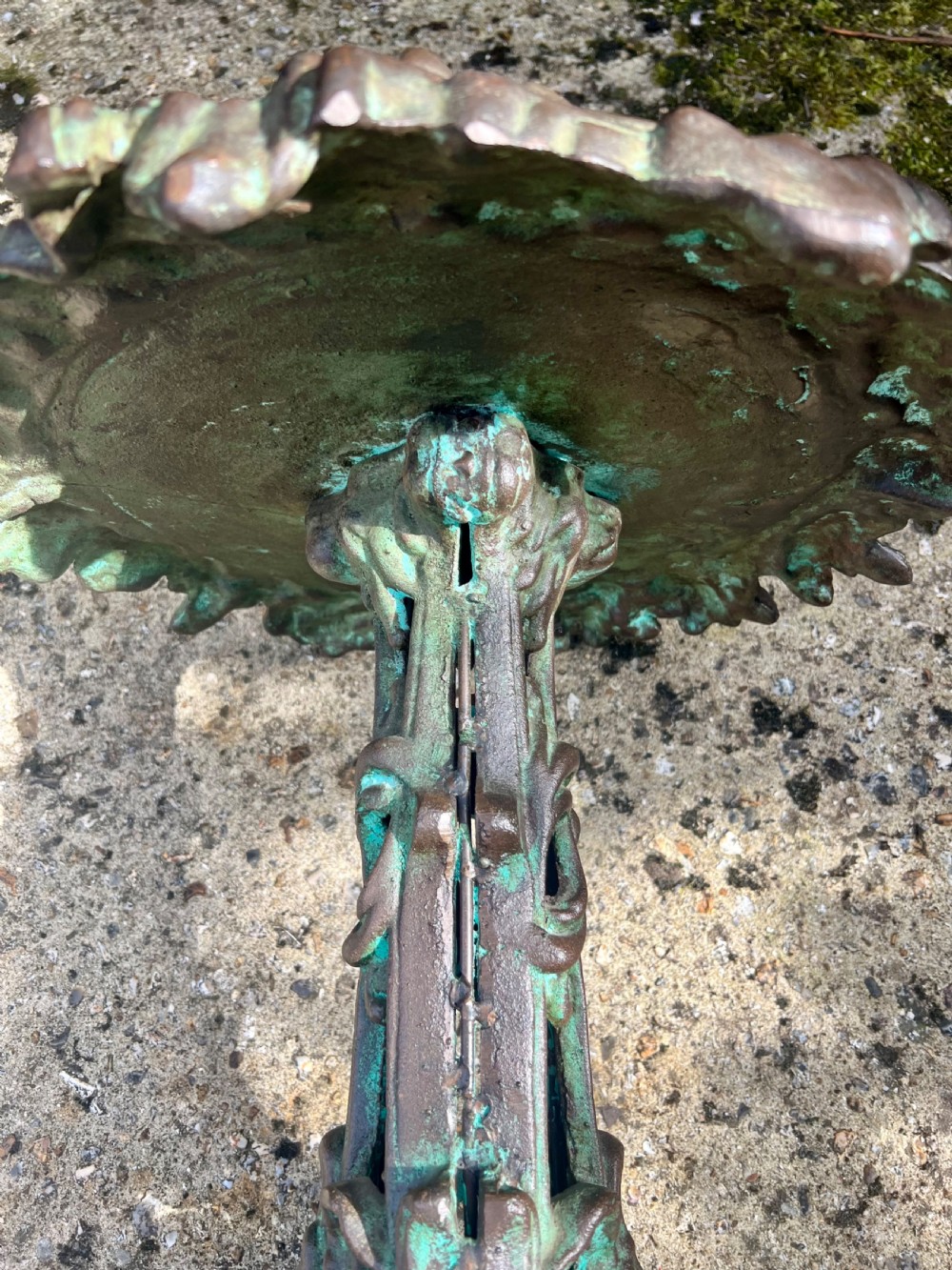 A pair of ornate cast iron pedestal tables with rococo scrollwork, tripod bases, and a verdigris green patinated finish. View VII