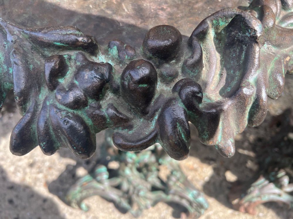 A pair of ornate cast iron pedestal tables with rococo scrollwork, tripod bases, and a verdigris green patinated finish. View IX