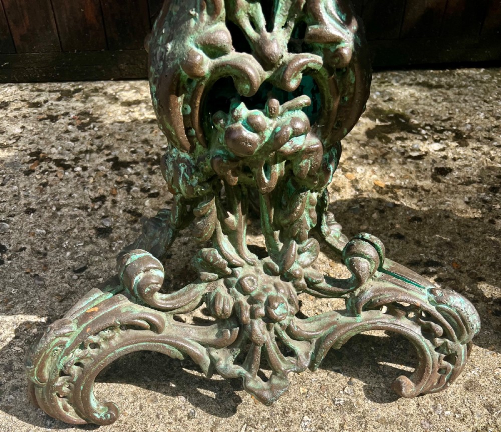 A pair of ornate cast iron pedestal tables with rococo scrollwork, tripod bases, and a verdigris green patinated finish. View XIII