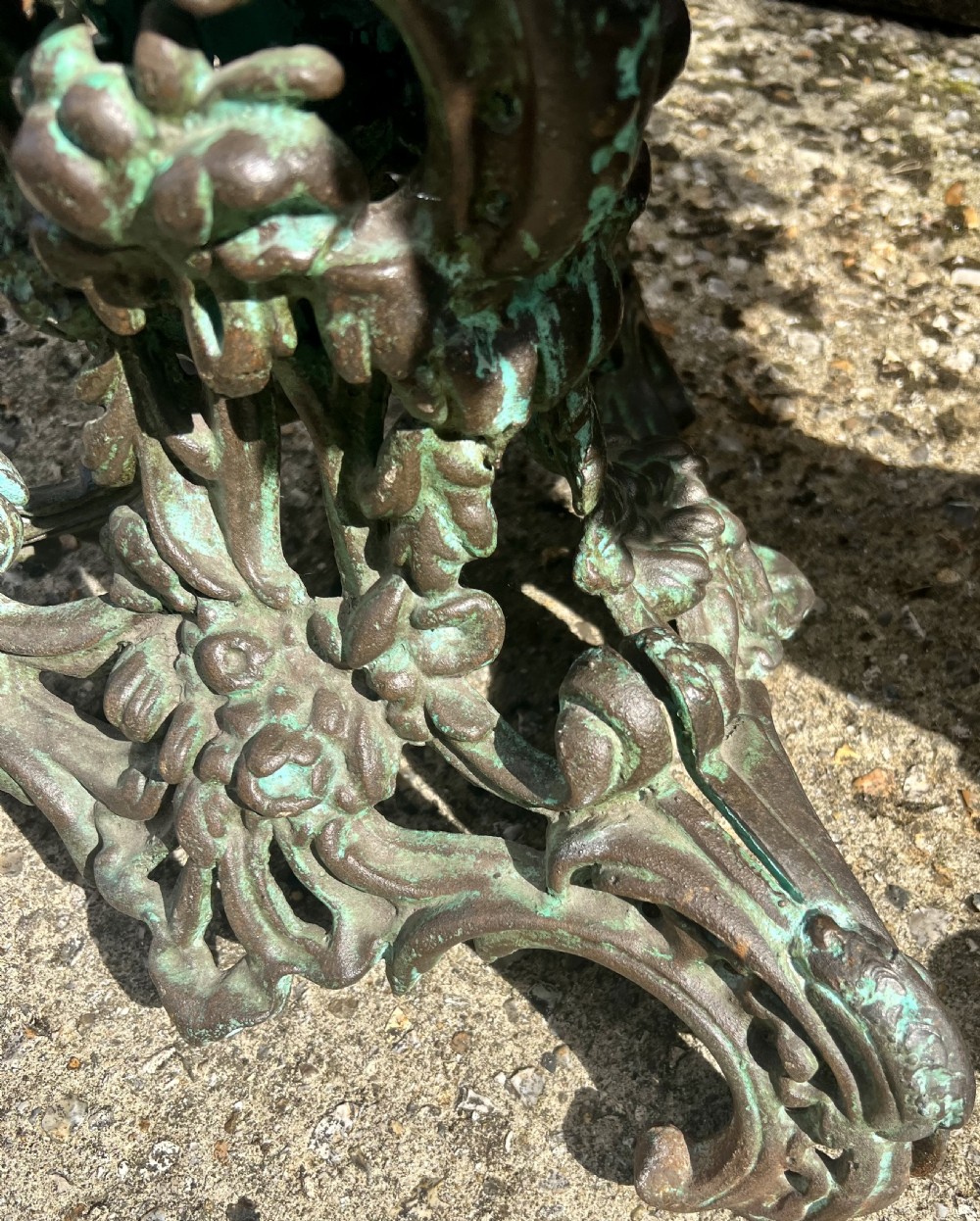 A pair of ornate cast iron pedestal tables with rococo scrollwork, tripod bases, and a verdigris green patinated finish. View XIV