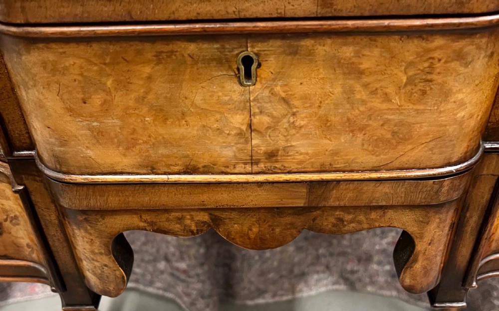 A burr walnut lowboy side table featuring five drawers, brass drop handles, a shaped apron, and four cabriole legs. View VIII
