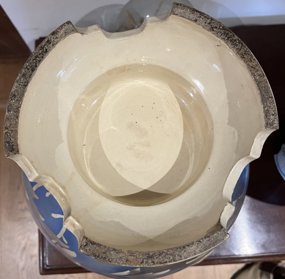 A pair of large Japanese Satsuma earthenware vases featuring painted blue and grey peonies, molded lion head handles, and a crackled cream glaze. View VII