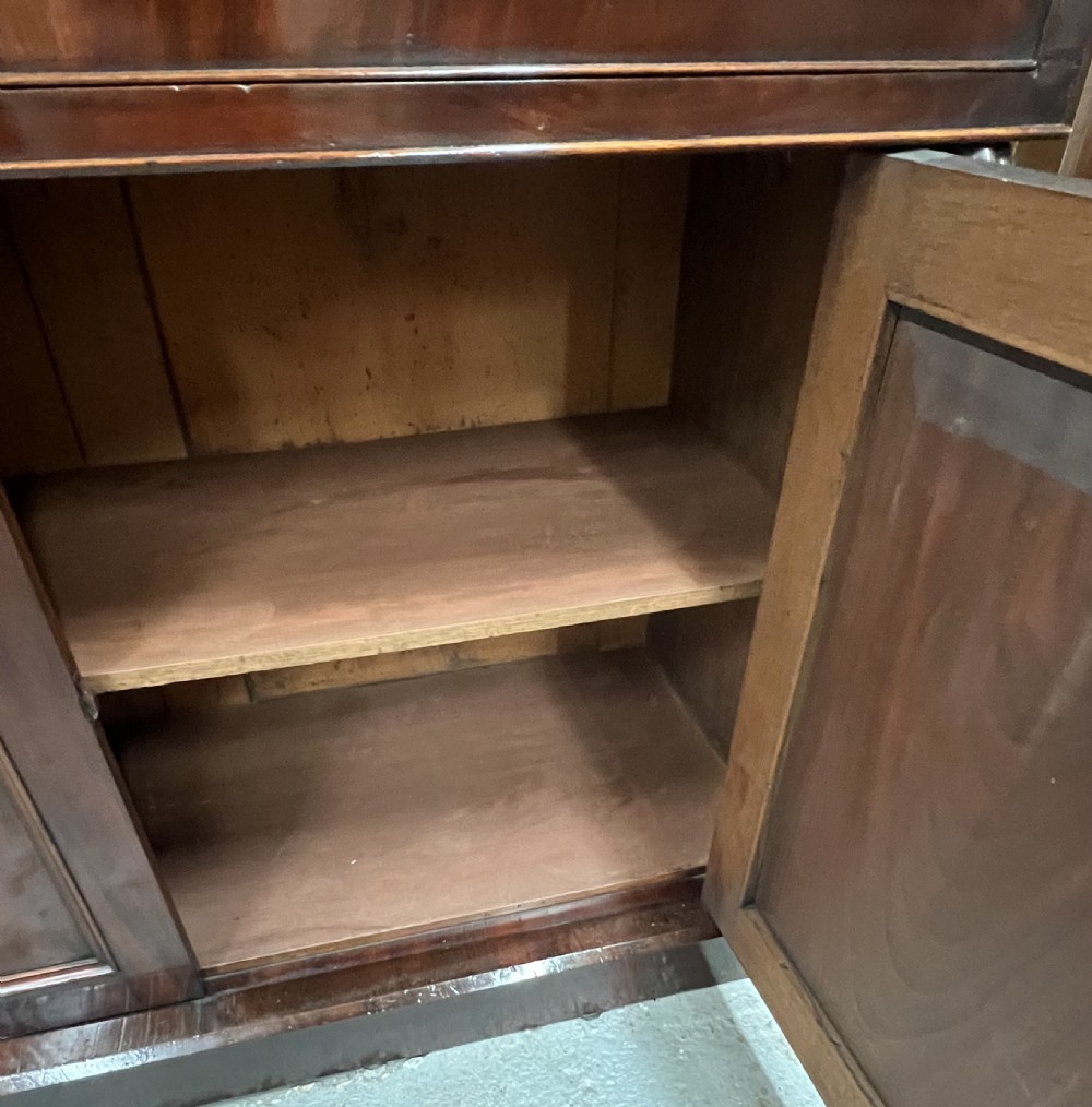 An antique mahogany secretaire bookcase featuring glazed upper doors, a middle drawer with turned knobs, and a double-door lower cabinet. View VIII