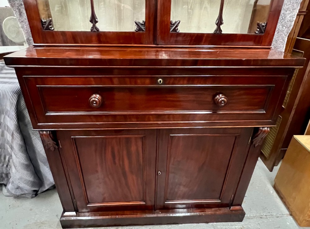 An antique mahogany secretaire bookcase featuring glazed upper doors, a middle drawer with turned knobs, and a double-door lower cabinet. View XI