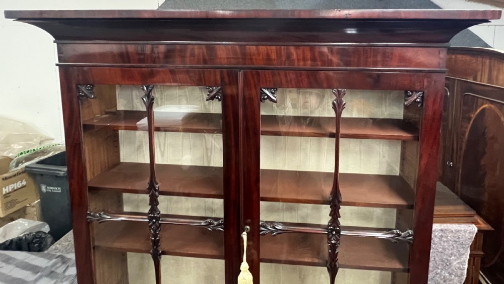 An antique mahogany secretaire bookcase featuring glazed upper doors, a middle drawer with turned knobs, and a double-door lower cabinet. View XIV