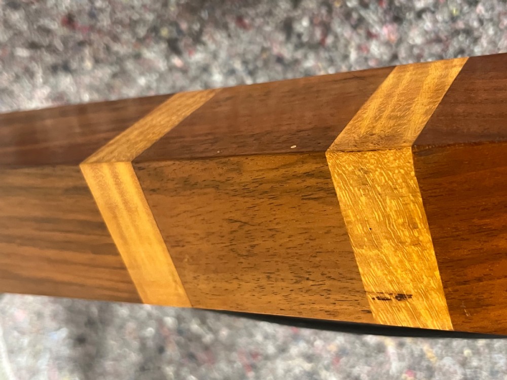 An Art Deco wooden standard lamp featuring a square column with contrasting inlaid bands set upon a stepped, multi-toned geometric base. View VI