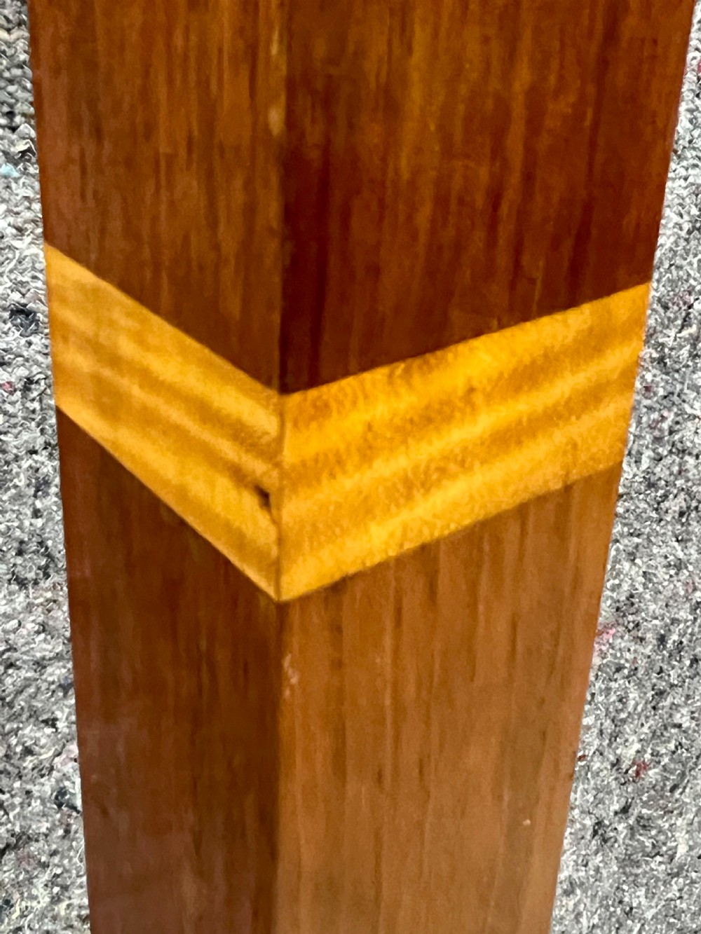 An Art Deco wooden standard lamp featuring a square column with contrasting inlaid bands set upon a stepped, multi-toned geometric base. View VII
