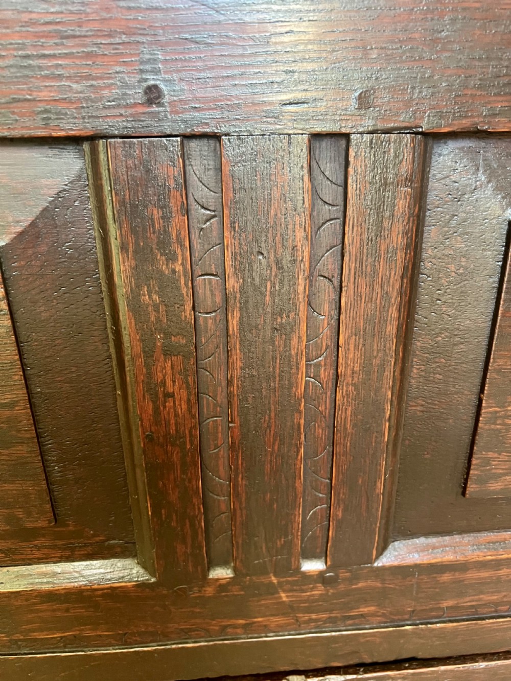 An eighteenth-century dark oak mule chest featuring a four-panel hinged lid, fielded panel front, and two lower drawers with brass drop handles. View III