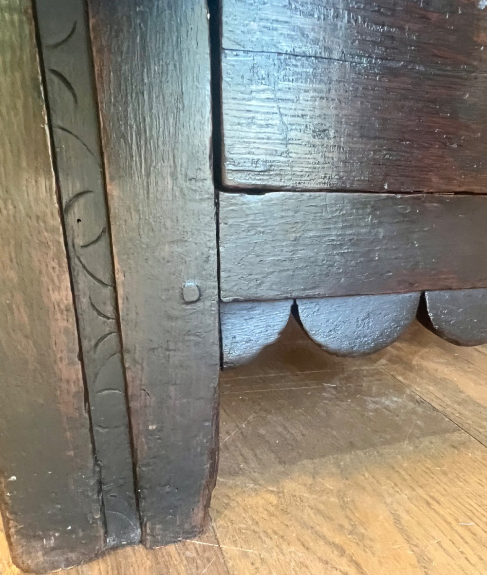 An eighteenth-century dark oak mule chest featuring a four-panel hinged lid, fielded panel front, and two lower drawers with brass drop handles. View VI