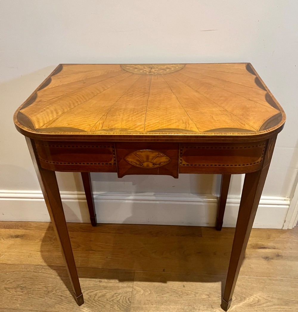 A Sheraton Revival satinwood side table featuring sunburst fan marquetry inlay and tapered legs.