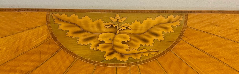 A Sheraton Revival satinwood side table featuring sunburst fan marquetry inlay and tapered legs. View V