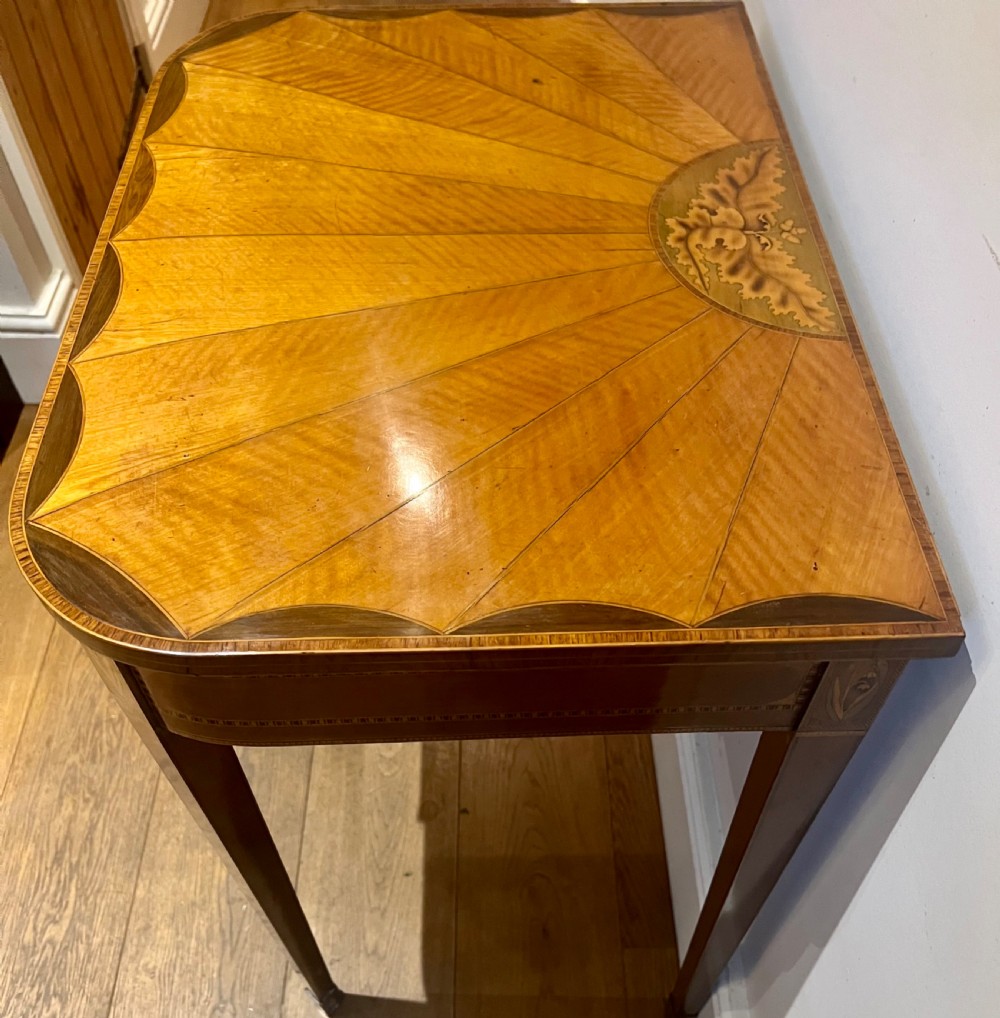 A Sheraton Revival satinwood side table featuring sunburst fan marquetry inlay and tapered legs. View VII