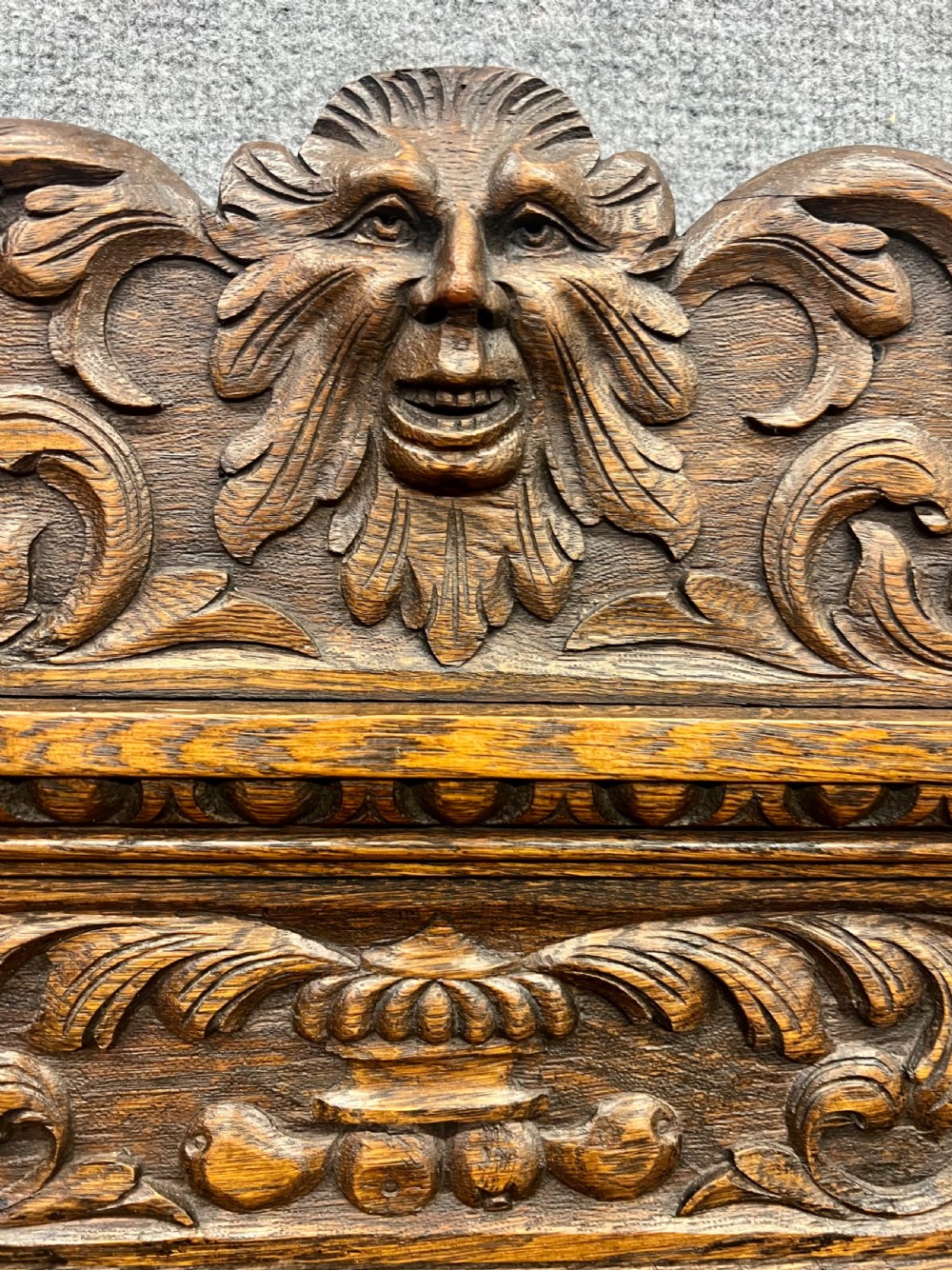 An antique carved oak hall stand set featuring a top wall-mounted mirror with coat pegs and a matching lower bench with integrated umbrella holders. View XI