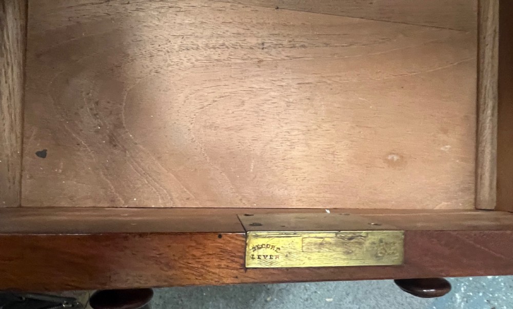 A nineteenth-century mahogany pedestal desk featuring a green leather writing top and nine drawers with turned wooden handles. View VII