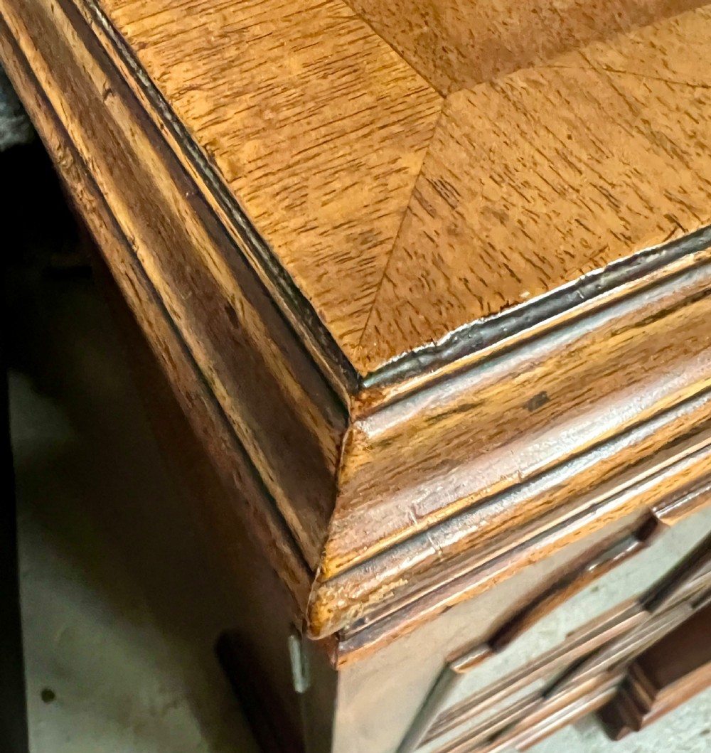 A low Queen Anne style walnut dwarf bookcase featuring a breakfront design with glazed side doors, a central veneered cupboard door, and bracket feet. View VII