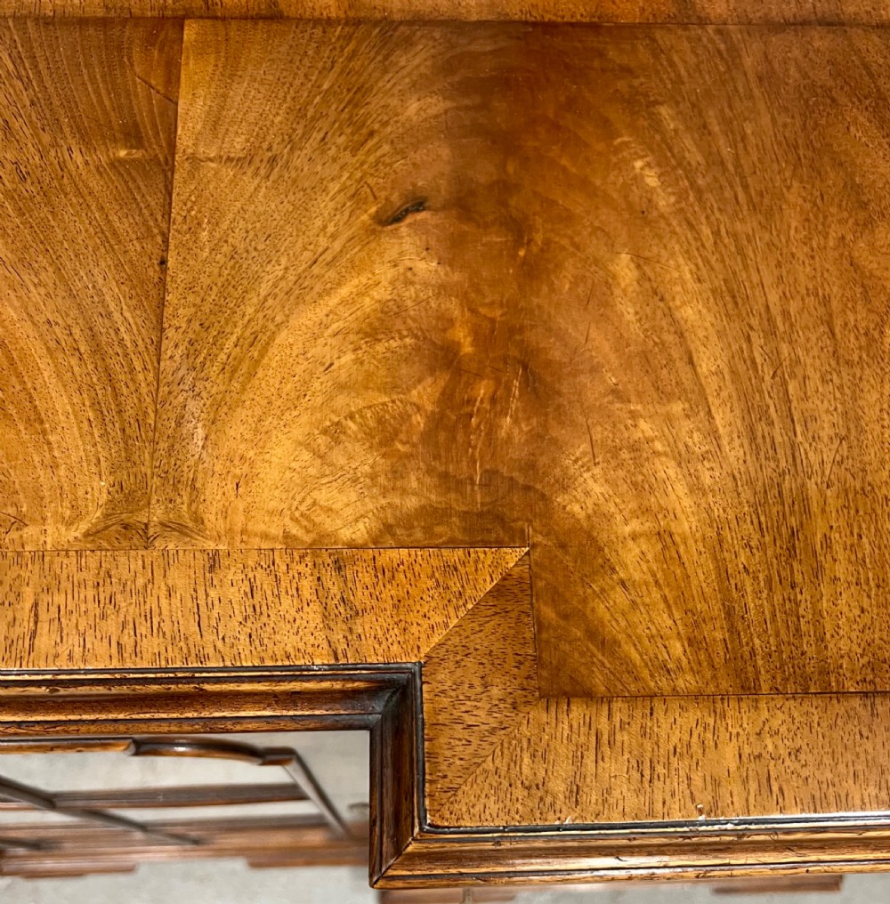 A low Queen Anne style walnut dwarf bookcase featuring a breakfront design with glazed side doors, a central veneered cupboard door, and bracket feet. View IX