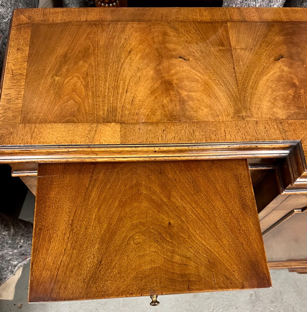 A low Queen Anne style walnut dwarf bookcase featuring a breakfront design with glazed side doors, a central veneered cupboard door, and bracket feet. View XII