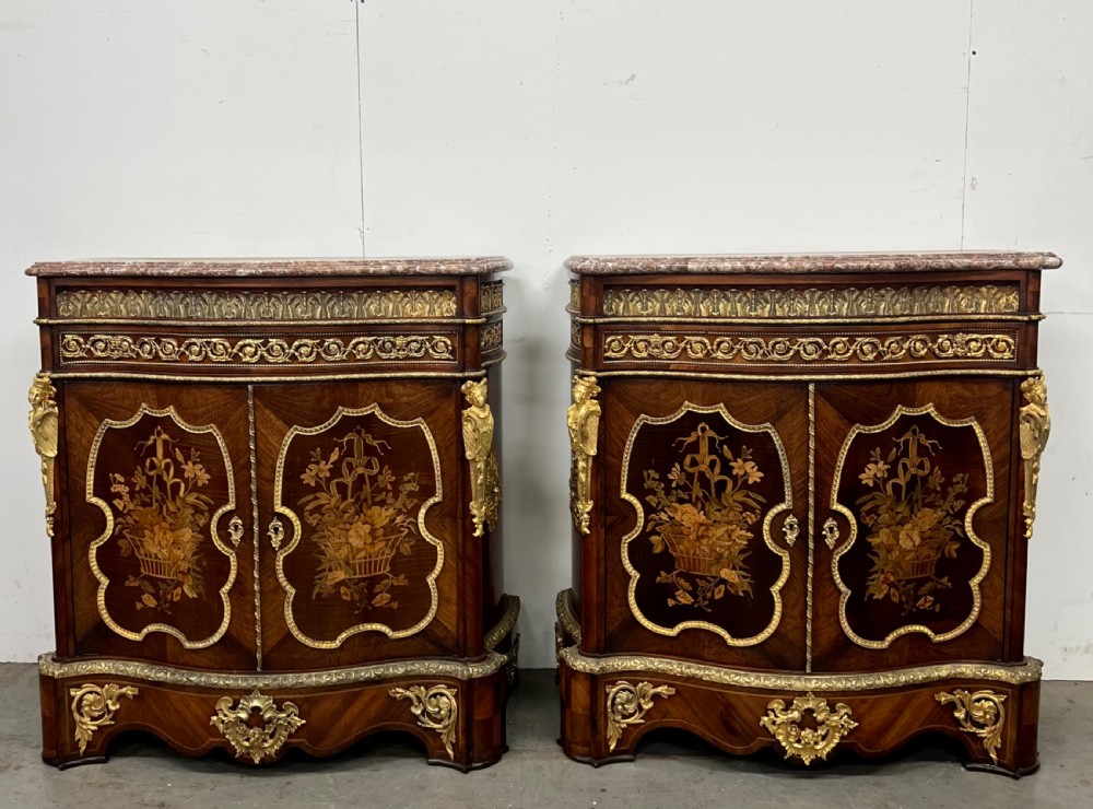 A pair of French Louis XV style kingwood side cabinets featuring floral marquetry, gilt-bronze ormolu mounts, and shaped pink marble tops. View II