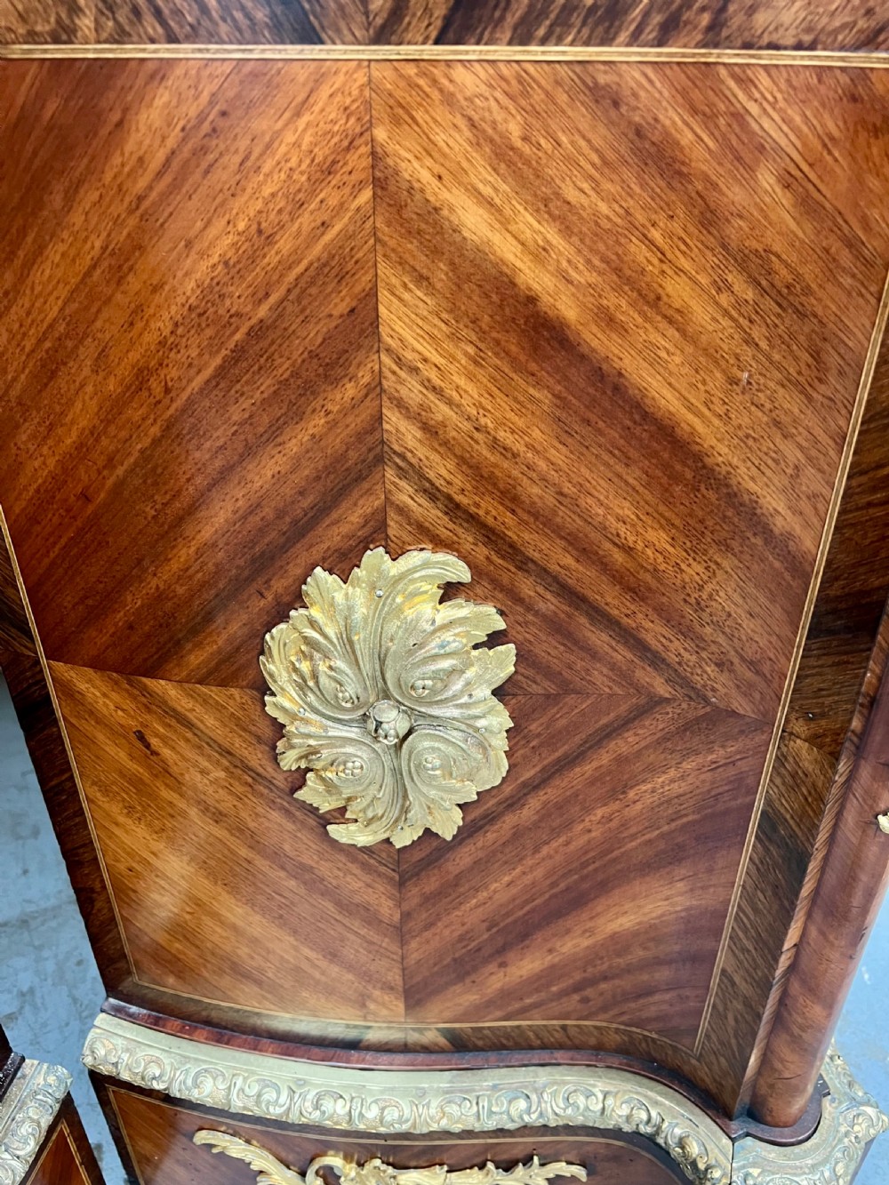 A pair of French Louis XV style kingwood side cabinets featuring floral marquetry, gilt-bronze ormolu mounts, and shaped pink marble tops. View XI