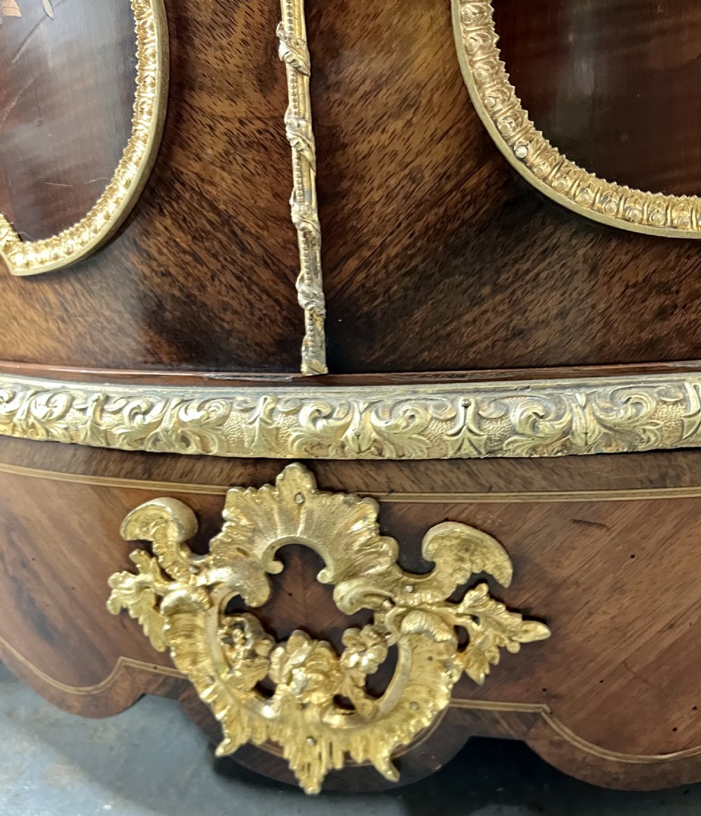 A pair of French Louis XV style kingwood side cabinets featuring floral marquetry, gilt-bronze ormolu mounts, and shaped pink marble tops. View XII