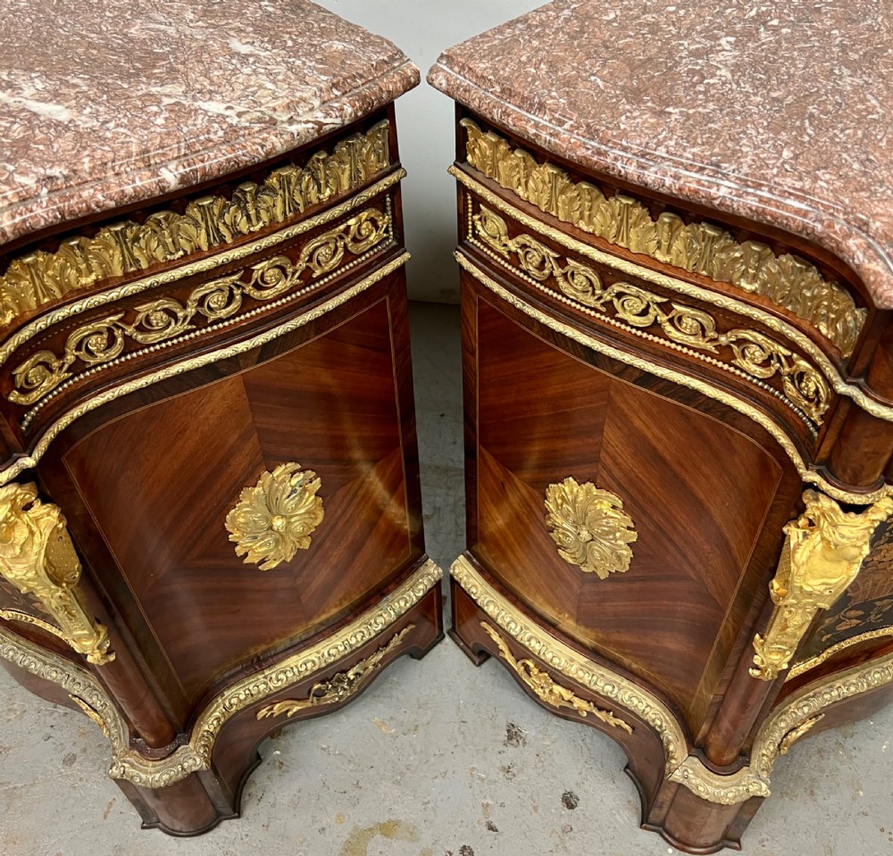 A pair of French Louis XV style kingwood side cabinets featuring floral marquetry, gilt-bronze ormolu mounts, and shaped pink marble tops. View XIV