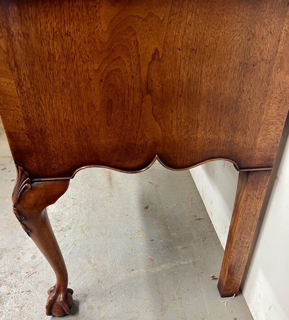 A tall burr walnut chest on stand featuring two short over three long drawers on top, three lower drawers, a shaped apron, and carved cabriole legs. View IX