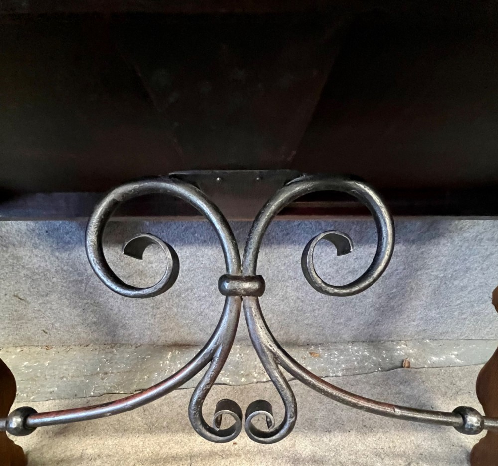 A dark oak Spanish console table featuring two carved drawers, lyre-shaped trestle legs, and a scrolled wrought iron stretcher. View VI