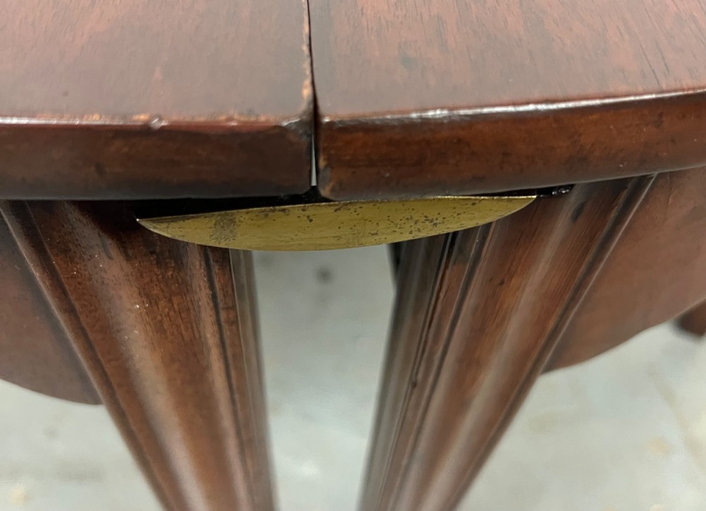 A pair of semi-circular George IV mahogany demilune console tables with polished surfaces and straight tapered legs. View VIII