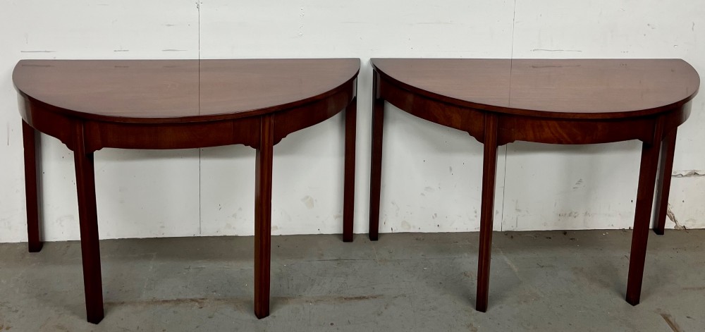 A pair of semi-circular George IV mahogany demilune console tables with polished surfaces and straight tapered legs. View IX