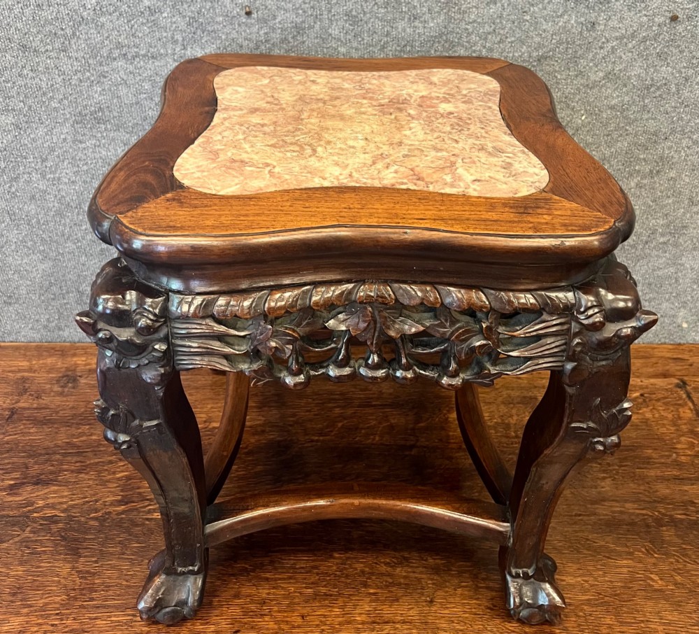 A dark carved Chinese hardwood stand featuring a pierced foliage apron, cabriole legs with mask details, and low stretchers. View II