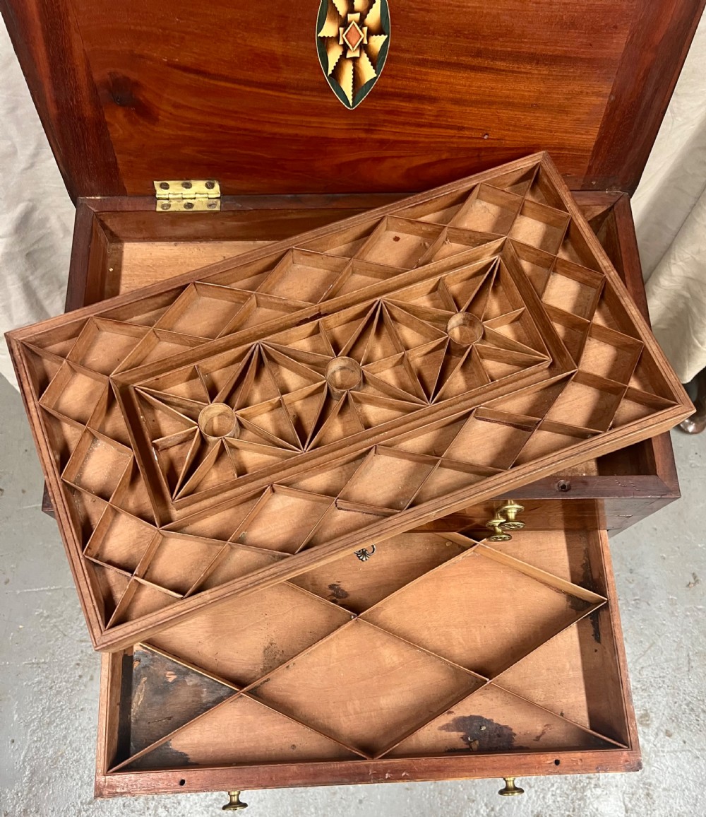 A Georgian mahogany collectors chest featuring five graduated drawers with brass rosette handles, resting on a stand with square tapered legs. View VIII