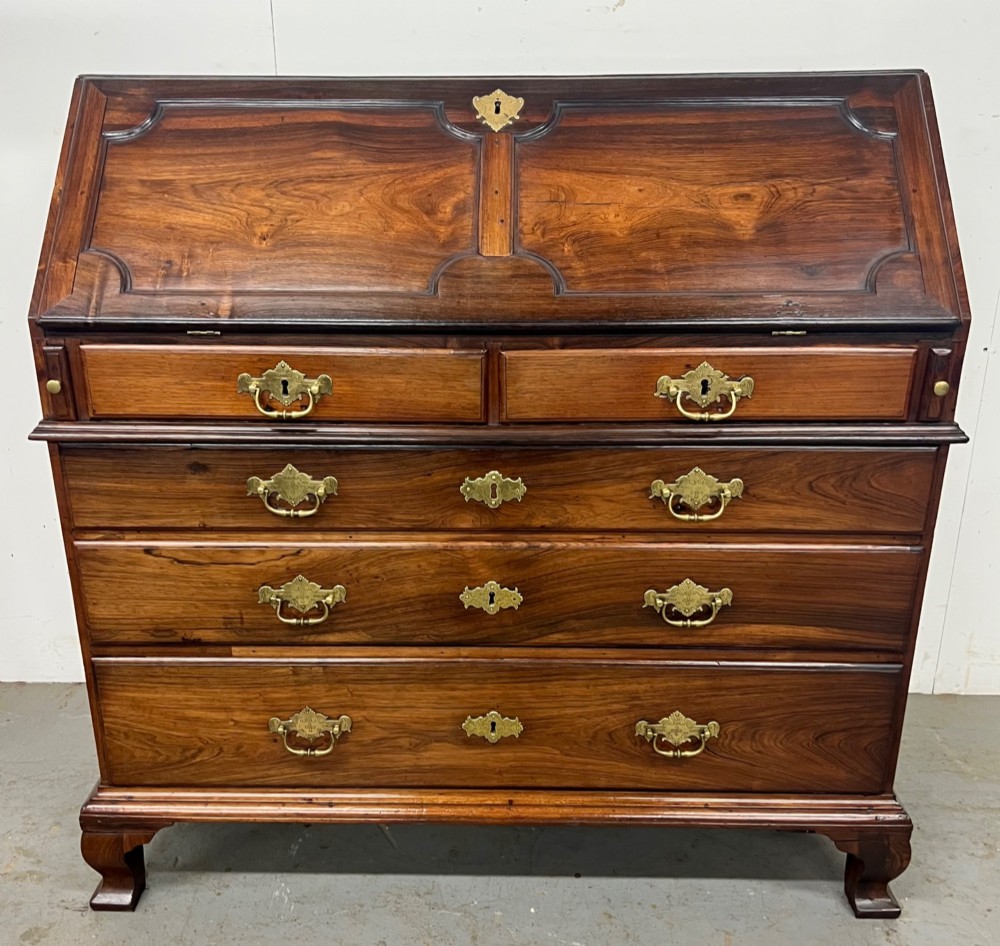 An 18th-century dark rosewood slant-front bureau shown open, featuring a stepped fitted interior, brass drop handles, and three long drawers below. View II