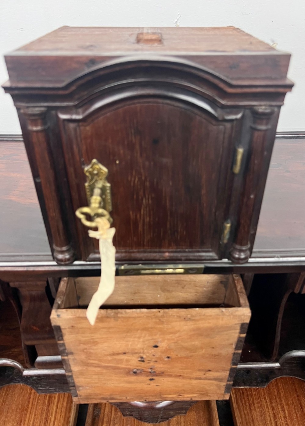 An 18th-century dark rosewood slant-front bureau shown open, featuring a stepped fitted interior, brass drop handles, and three long drawers below. View XI