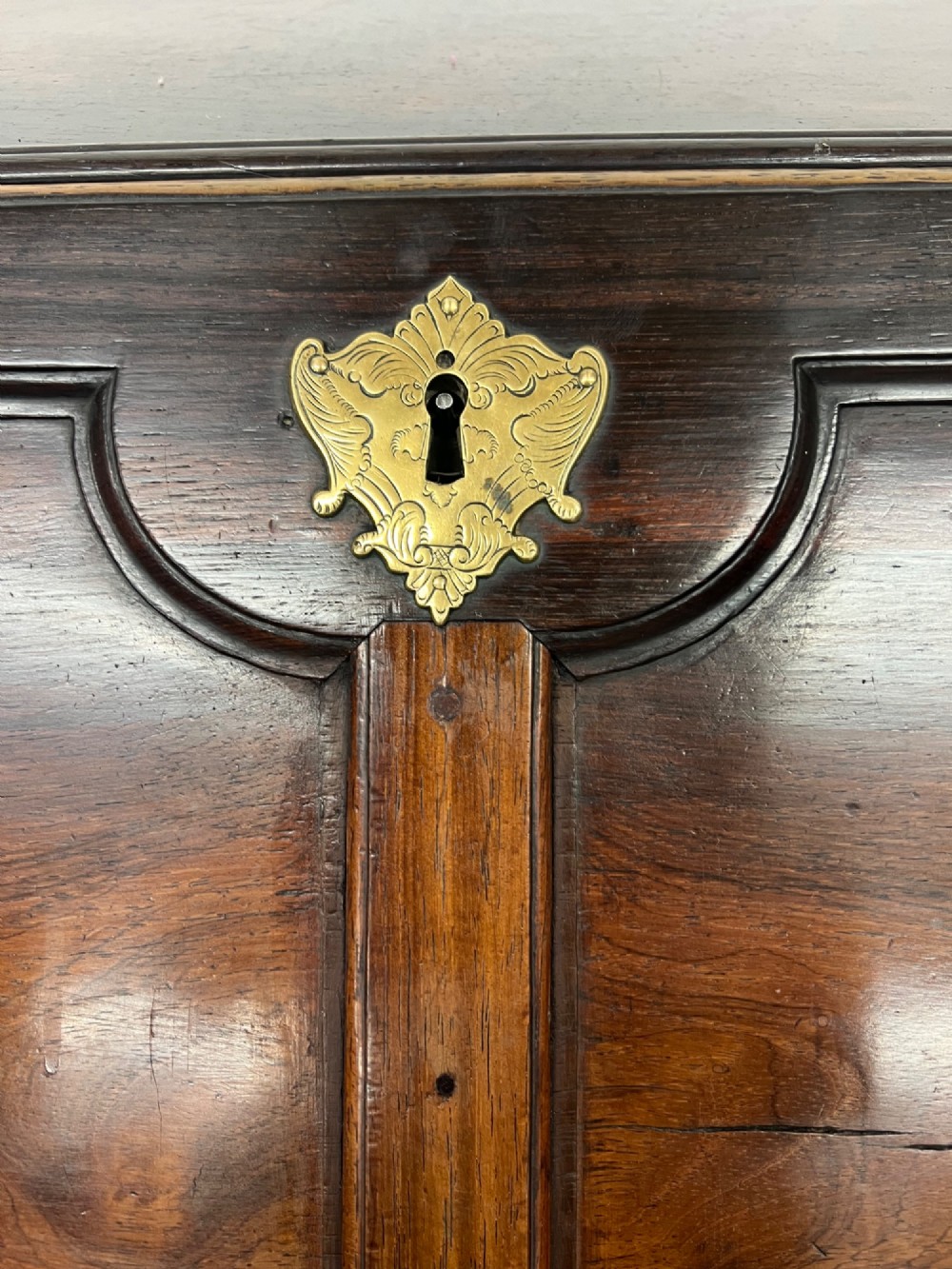 An 18th-century dark rosewood slant-front bureau shown open, featuring a stepped fitted interior, brass drop handles, and three long drawers below. View XIV