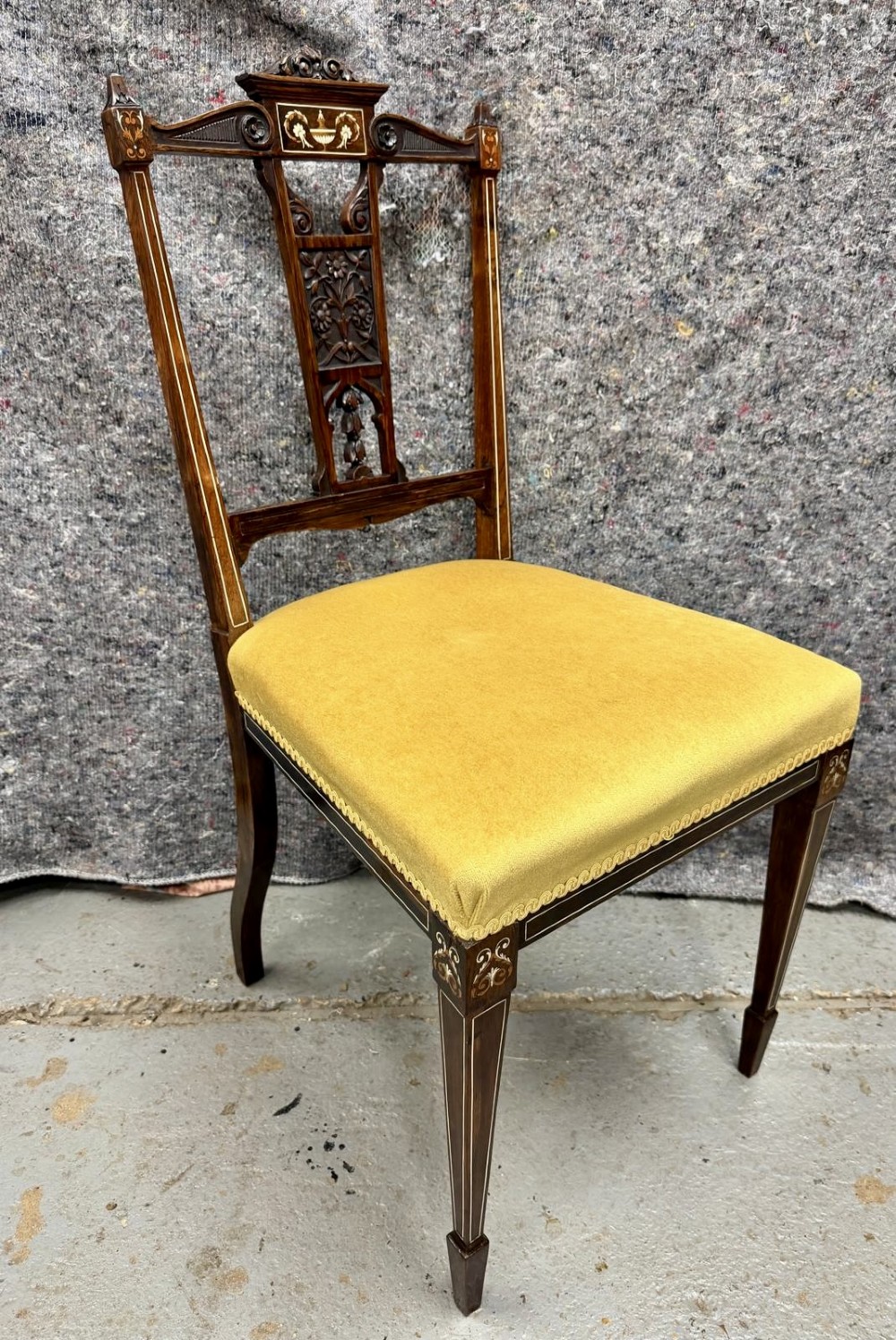 A set of four late Victorian inlaid rosewood side chairs featuring carved back splats with urn marquetry and yellow upholstered seats. View IV