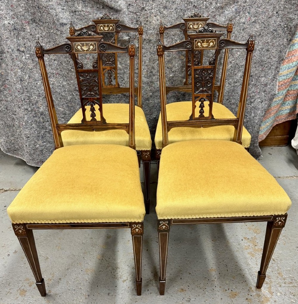 A set of four late Victorian inlaid rosewood side chairs featuring carved back splats with urn marquetry and yellow upholstered seats. View V