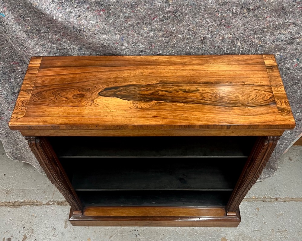 A low Regency open bookcase crafted from dark polished wood featuring carved twist mouldings on the side columns and three open shelves above a solid plinth base. View IV