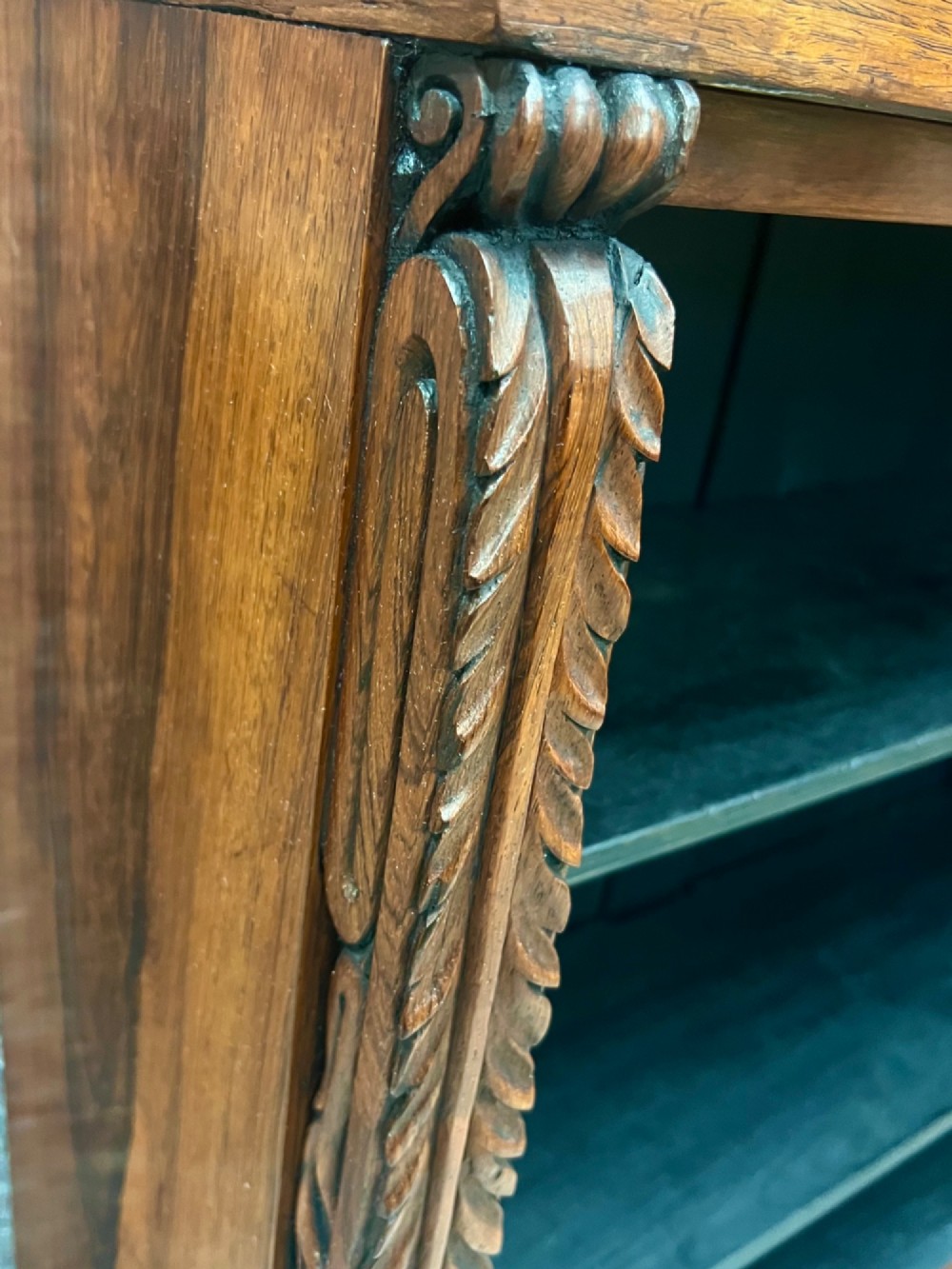 A low Regency open bookcase crafted from dark polished wood featuring carved twist mouldings on the side columns and three open shelves above a solid plinth base. View VI