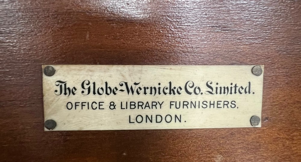 A five-tier dark mahogany Globe Wernicke stacking bookcase with glazed lift-up doors and maker labels. View III