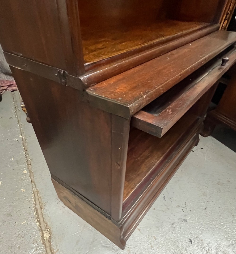 A five-tier dark mahogany Globe Wernicke stacking bookcase with glazed lift-up doors and maker labels. View VI