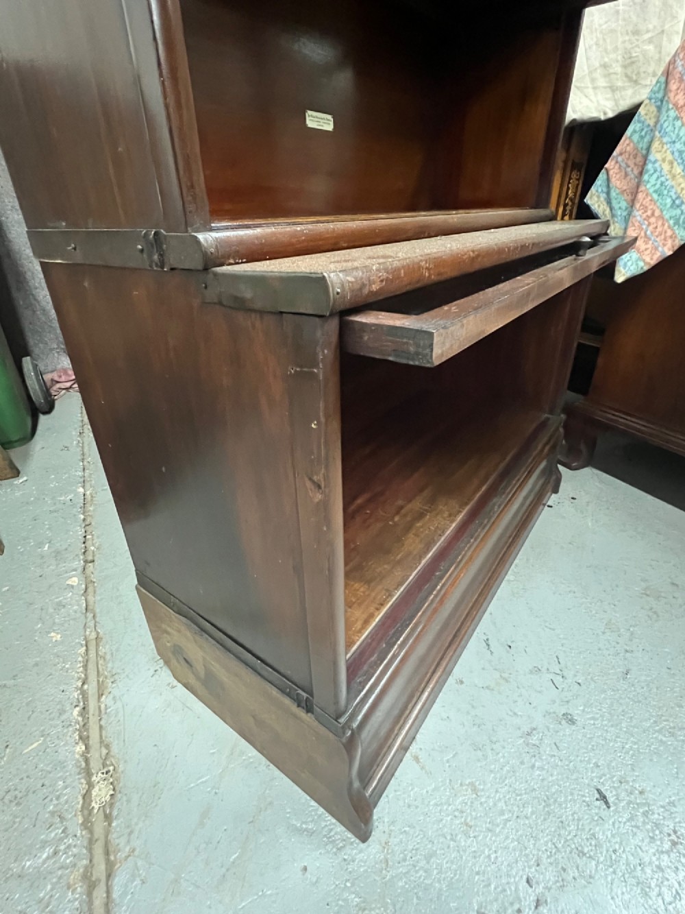 A five-tier dark mahogany Globe Wernicke stacking bookcase with glazed lift-up doors and maker labels. View VII