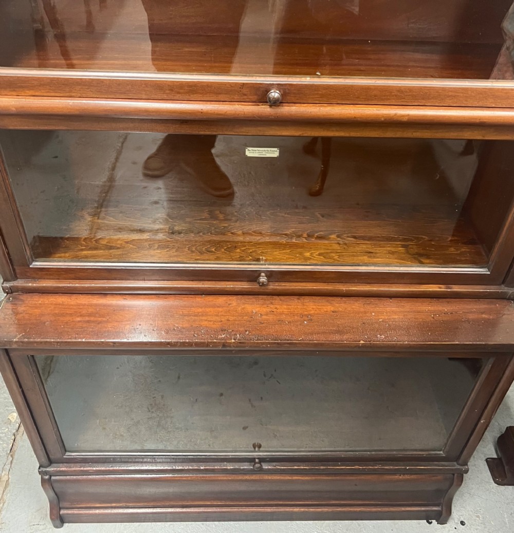 A five-tier dark mahogany Globe Wernicke stacking bookcase with glazed lift-up doors and maker labels. View VIII