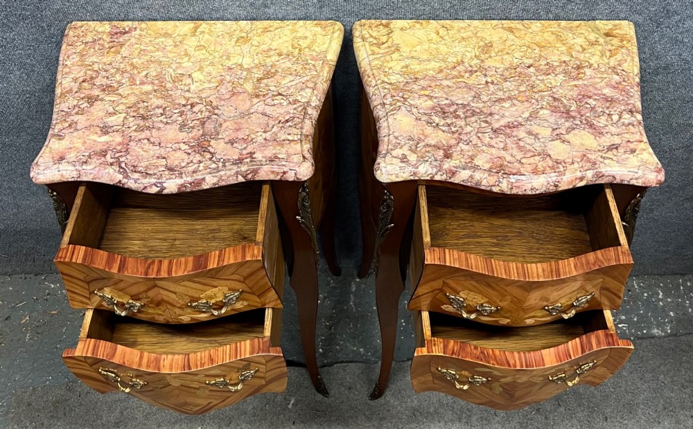A pair of French Louis XV style bedside chests featuring floral marquetry inlay, curved cabriole legs, decorative metal mounts, and shaped pink marble tops. View II